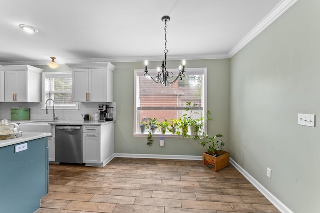 707 Bradford Pl, Murfreesboro, TN 37130 - kitchen with stainless steel dishwasher, a chandelier, light countertops, white cabinets, and tasteful backsplash