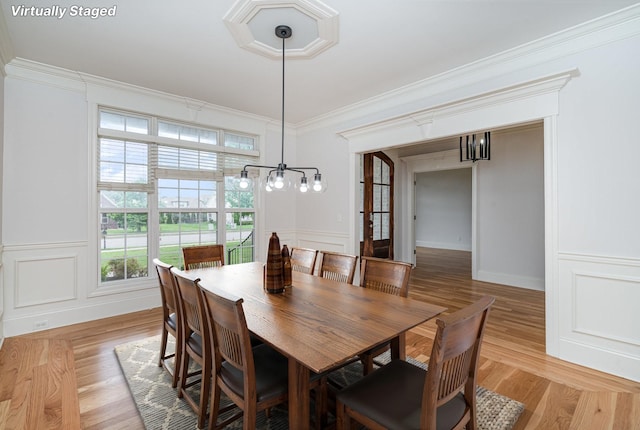 2804 Battleground Dr, Murfreesboro, TN 37129 - dining space with a chandelier, a decorative wall, crown molding, and light wood-style flooring