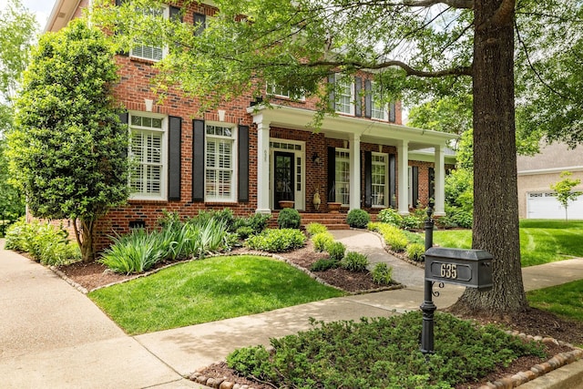 635 Band Dr, Franklin, TN 37064 - view of front of home with brick siding, a porch, and a front yard