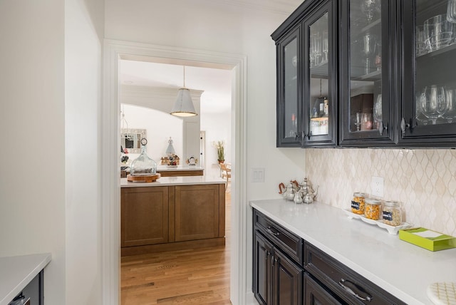 635 Band Dr, Franklin, TN 37064 - indoor dry bar with decorative backsplash, light wood-style floors, and pendant lighting