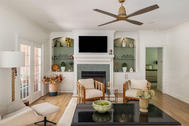 635 Band Dr, Franklin, TN 37064 - living room featuring crown molding, light wood finished floors, ceiling fan, a fireplace, and baseboards