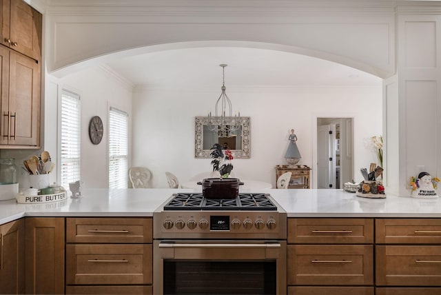 635 Band Dr, Franklin, TN 37064 - kitchen with high end range, arched walkways, a peninsula, light countertops, and brown cabinetry