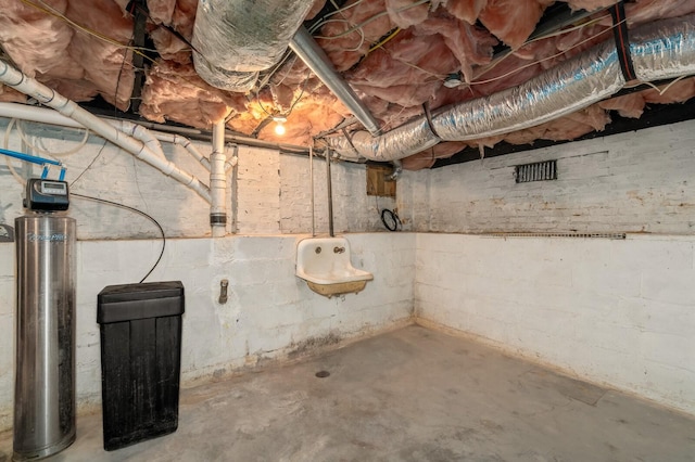 unfinished basement with a water softener