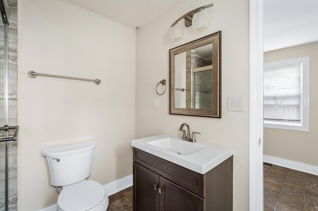 full bathroom featuring baseboards, a shower with shower door, vanity, and toilet