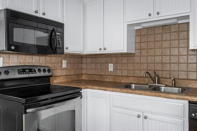 kitchen featuring black appliances, a sink, backsplash, and white cabinetry
