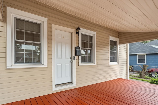 deck with a porch and fence