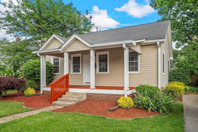 bungalow featuring covered porch and a shingled roof