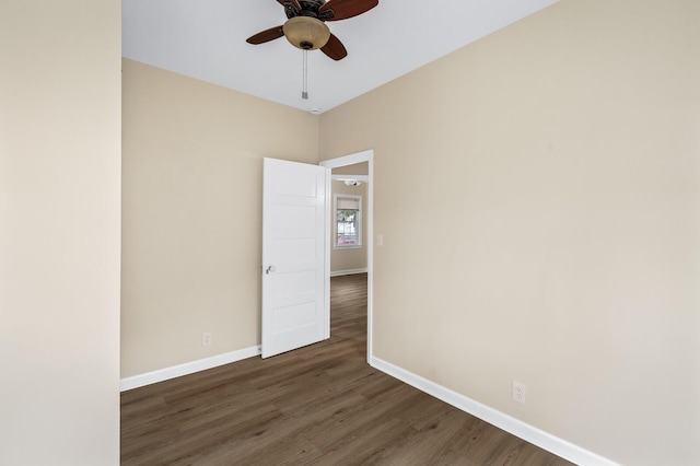 spare room featuring a ceiling fan, wood finished floors, and baseboards