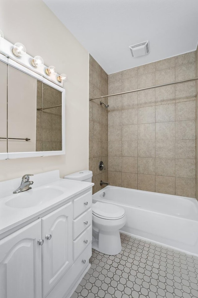 bathroom featuring tub / shower combination, toilet, and vanity