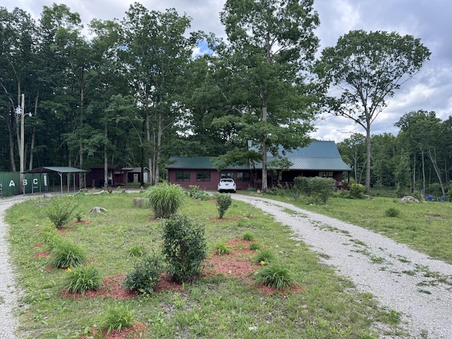 142 Kimberly Rd, Hohenwald, TN 38462 - view of front of home featuring gravel driveway, a detached carport, and metal roof