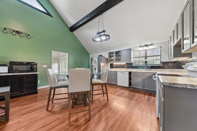 142 Kimberly Rd, Hohenwald, TN 38462 - kitchen with white appliances, gray cabinets, decorative backsplash, high vaulted ceiling, and light wood finished floors