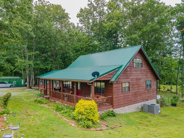 142 Kimberly Rd, Hohenwald, TN 38462 - rustic home with a front yard, a metal roof, and a porch
