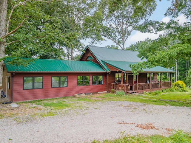 142 Kimberly Rd, Hohenwald, TN 38462 - rustic home with a metal roof and covered porch