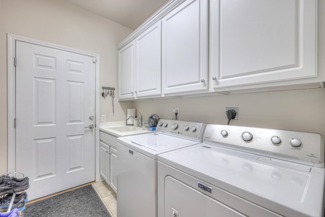 clothes washing area featuring separate washer and dryer, cabinet space, and light tile patterned floors