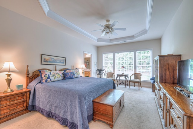 bedroom with light carpet, a raised ceiling, a ceiling fan, and ornamental molding