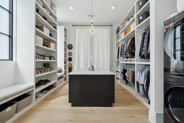 9052 Passiflora Ct, College Grove, TN 37046 - walk in closet with stacked washer / drying machine and light wood finished floors