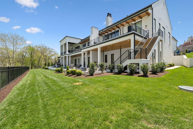 9052 Passiflora Ct, College Grove, TN 37046 - rear view of house featuring stucco siding, stairway, a chimney, and a patio