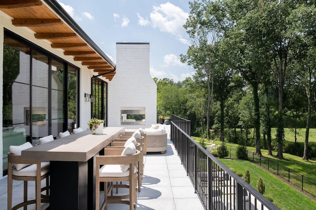 9052 Passiflora Ct, College Grove, TN 37046 - balcony featuring an outdoor brick fireplace, a patio, and outdoor dining space