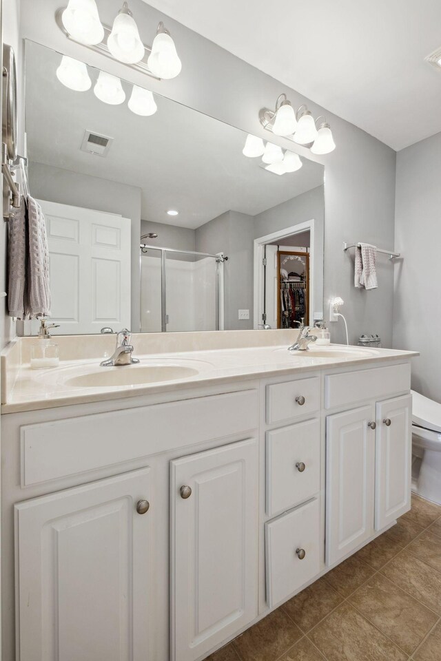 825 S Browns Ln Unit 1501, Gallatin, TN 37066 - bathroom with a shower stall, toilet, double vanity, and tile patterned flooring