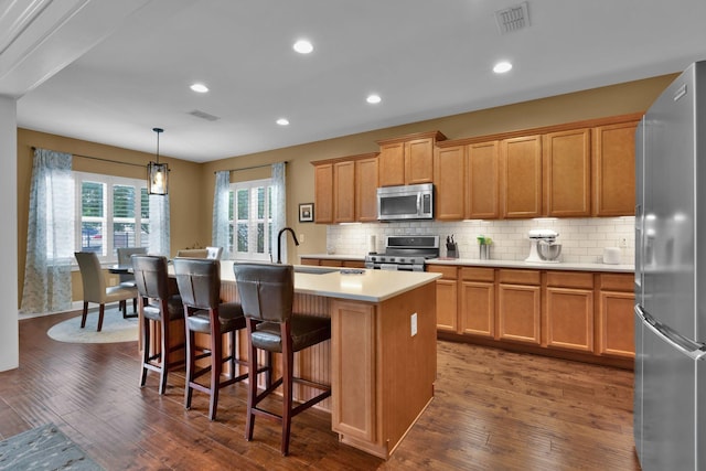 606 Tywater Crossing Blvd, Franklin, TN 37064 - kitchen with appliances with stainless steel finishes, dark wood-type flooring, light countertops, a center island with sink, and recessed lighting