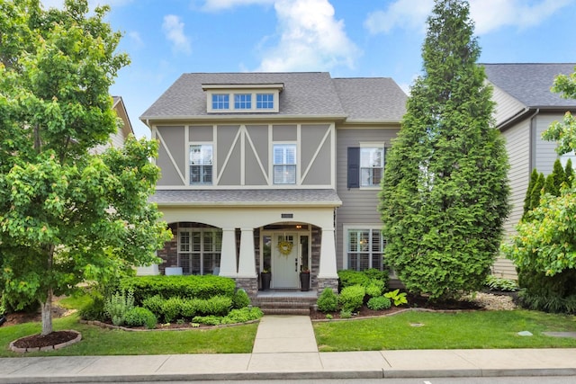 606 Tywater Crossing Blvd, Franklin, TN 37064 - english style home featuring a front lawn, a shingled roof, and covered porch