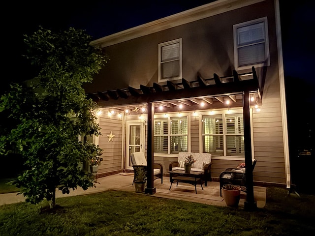 606 Tywater Crossing Blvd, Franklin, TN 37064 - back of house at night featuring a pergola, a patio, outdoor lounge area, and a yard