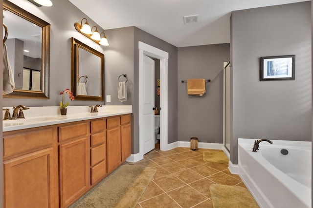 606 Tywater Crossing Blvd, Franklin, TN 37064 - bathroom with double vanity, tile patterned floors, a bath, a stall shower, and toilet