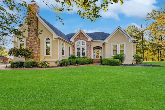 2926 Lisa Dr, Springfield, TN 37172 - view of front of home with stucco siding, a front lawn, a chimney, and stone siding