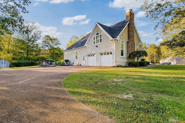 2926 Lisa Dr, Springfield, TN 37172 - view of home's exterior featuring stucco siding, asphalt driveway, a chimney, a storage shed, and a yard