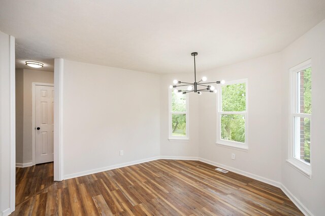 1011 Bon Meade Dr, Burns, TN 37029 - spare room with a chandelier, dark wood-style flooring, and baseboards