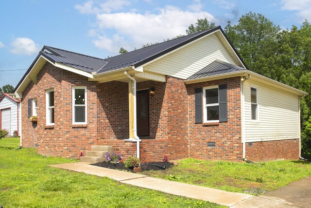 1011 Bon Meade Dr, Burns, TN 37029 - view of front of home with a front yard, metal roof, brick siding, and crawl space