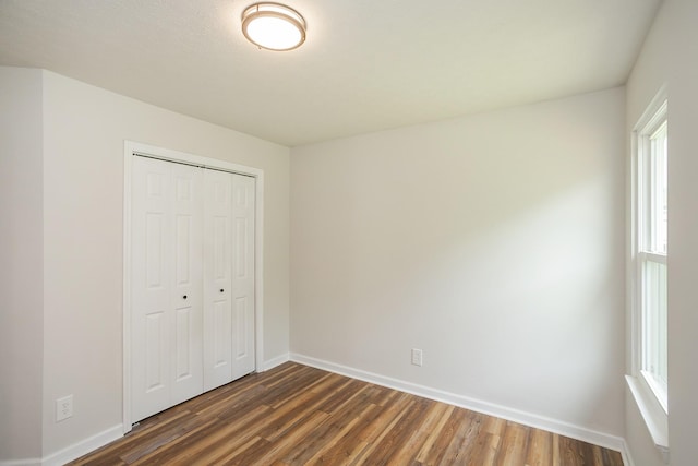 1011 Bon Meade Dr, Burns, TN 37029 - unfurnished bedroom with dark wood finished floors, baseboards, and a closet