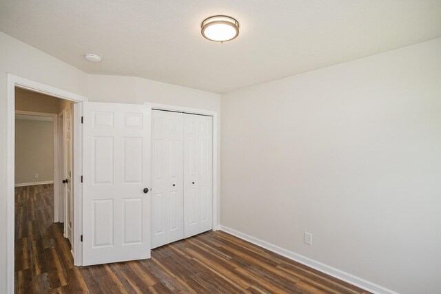 1011 Bon Meade Dr, Burns, TN 37029 - unfurnished bedroom with a closet, baseboards, and dark wood-style flooring