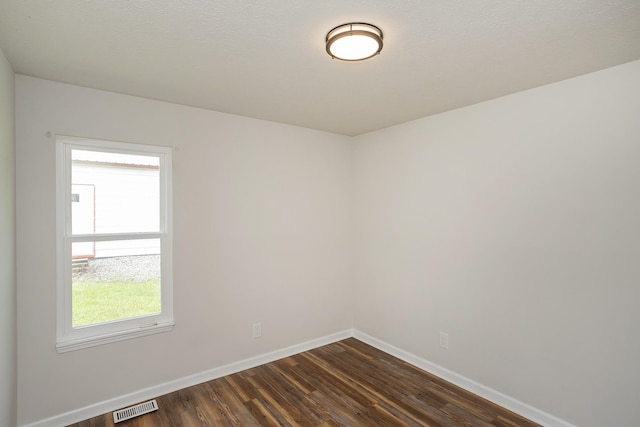 1011 Bon Meade Dr, Burns, TN 37029 - empty room featuring baseboards, dark wood finished floors, and healthy amount of natural light