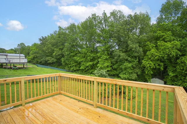 1011 Bon Meade Dr, Burns, TN 37029 - deck featuring a storage shed, a lawn, an outbuilding, and view of wooded area