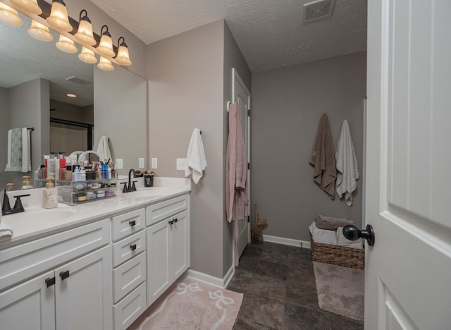 3307 Stormello Ln, Murfreesboro, TN 37128 - bathroom with baseboards, double vanity, a textured ceiling, and stone finish floors