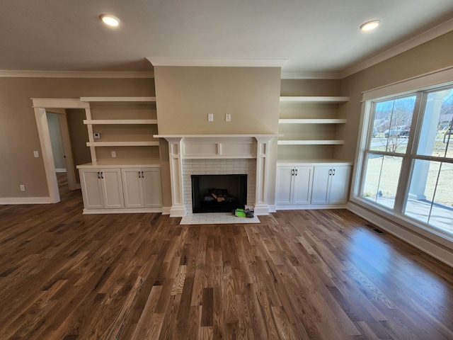 240 S Tunnel Rd, Portland, TN 37148 - unfurnished living room featuring crown molding, baseboards, a brick fireplace, built in shelves, and dark wood-style floors