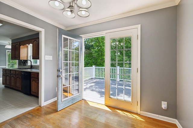 114 Clover Dr, Columbia, TN 38401 - doorway featuring a sink, a chandelier, crown molding, baseboards, and light wood-style floors