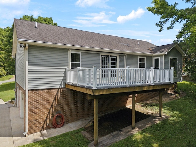114 Clover Dr, Columbia, TN 38401 - back of property with a deck, brick siding, roof with shingles, and a yard