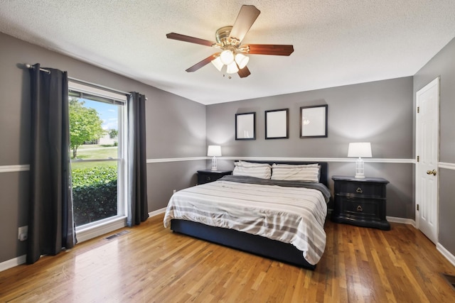 114 Clover Dr, Columbia, TN 38401 - bedroom with wood finished floors, a textured ceiling, baseboards, and a ceiling fan