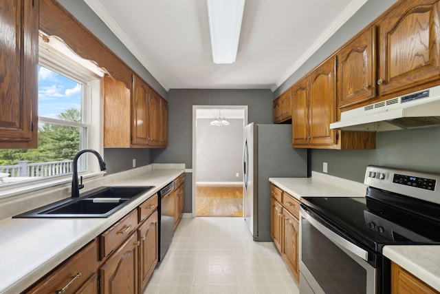 114 Clover Dr, Columbia, TN 38401 - kitchen with appliances with stainless steel finishes, under cabinet range hood, a sink, light countertops, and brown cabinets