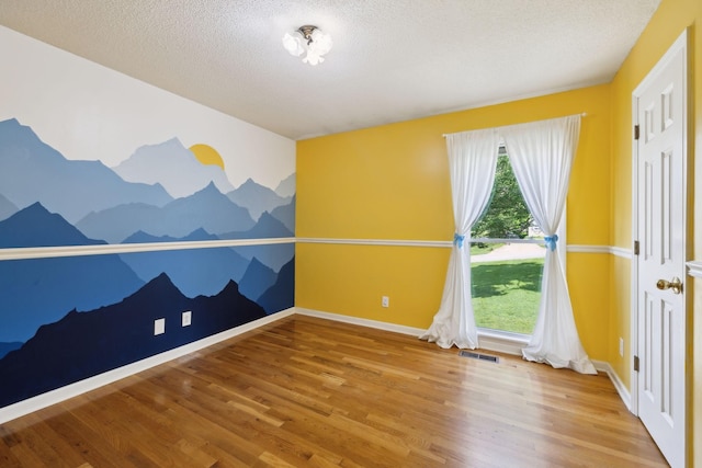 114 Clover Dr, Columbia, TN 38401 - unfurnished room featuring wood finished floors, a textured ceiling, and baseboards