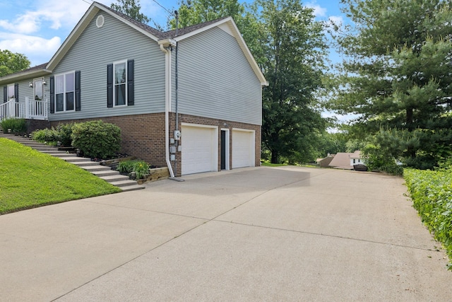 114 Clover Dr, Columbia, TN 38401 - view of property exterior featuring brick siding, a garage, driveway, and stairs