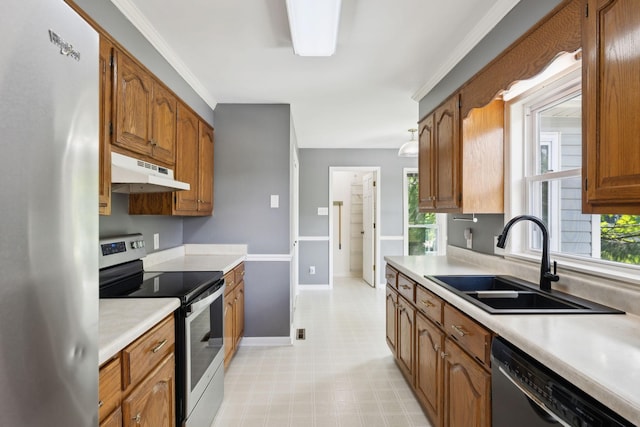 114 Clover Dr, Columbia, TN 38401 - kitchen featuring appliances with stainless steel finishes, under cabinet range hood, a sink, light countertops, and brown cabinetry