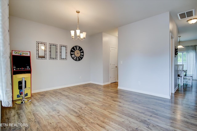 1242 Bill Wallace Dr, Friendsville, TN 37737 - spare room featuring wood finished floors, a chandelier, and baseboards