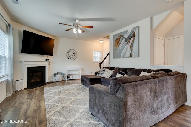 1242 Bill Wallace Dr, Friendsville, TN 37737 - living room with a ceiling fan, a fireplace with flush hearth, wood finished floors, and stairs