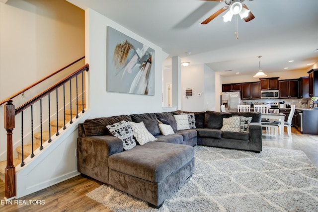 1242 Bill Wallace Dr, Friendsville, TN 37737 - living room with light wood finished floors, ceiling fan, stairway, baseboards, and recessed lighting