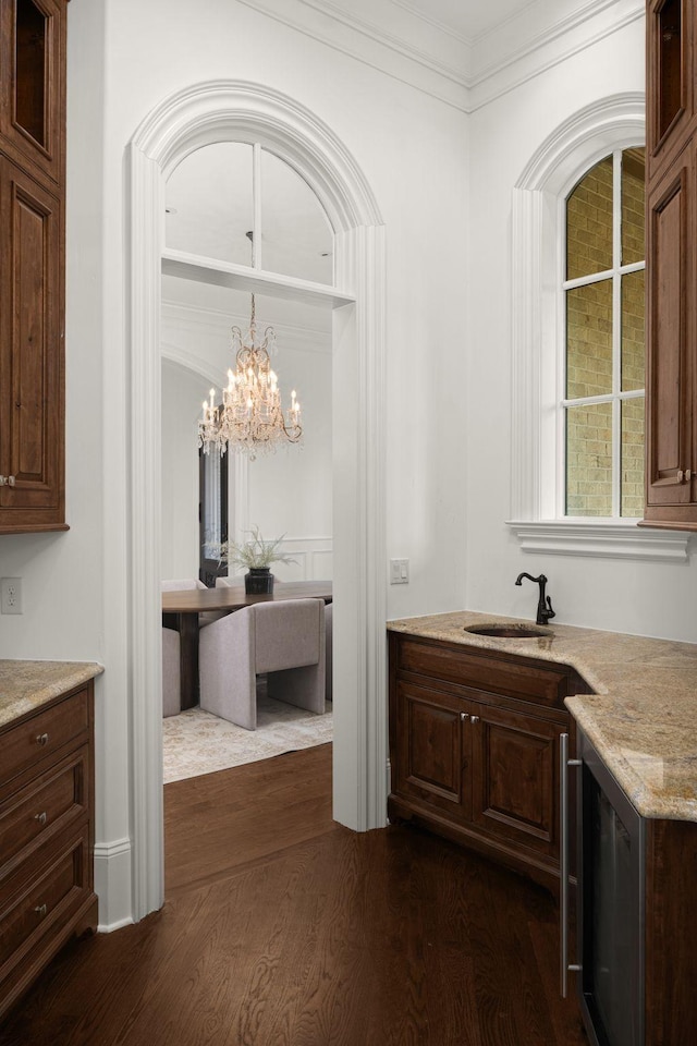 443 Canterbury Rise, Franklin, TN 37067 - bar with crown molding, dark wood-style flooring, a sink, and a chandelier