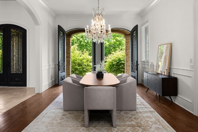 443 Canterbury Rise, Franklin, TN 37067 - dining area with french doors, a chandelier, arched walkways, wood finished floors, and crown molding