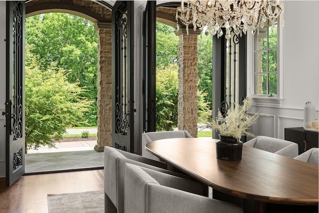 443 Canterbury Rise, Franklin, TN 37067 - dining area with a chandelier, wood finished floors, and wainscoting